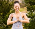 Portrait of Desireé Melonas in a yoga pose